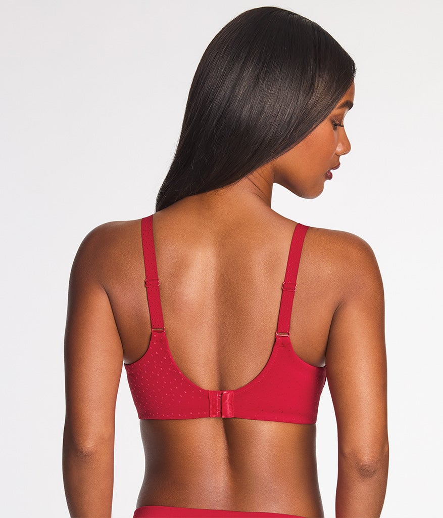 Woman with long dark hair wearing a red textured underwire bra, back view